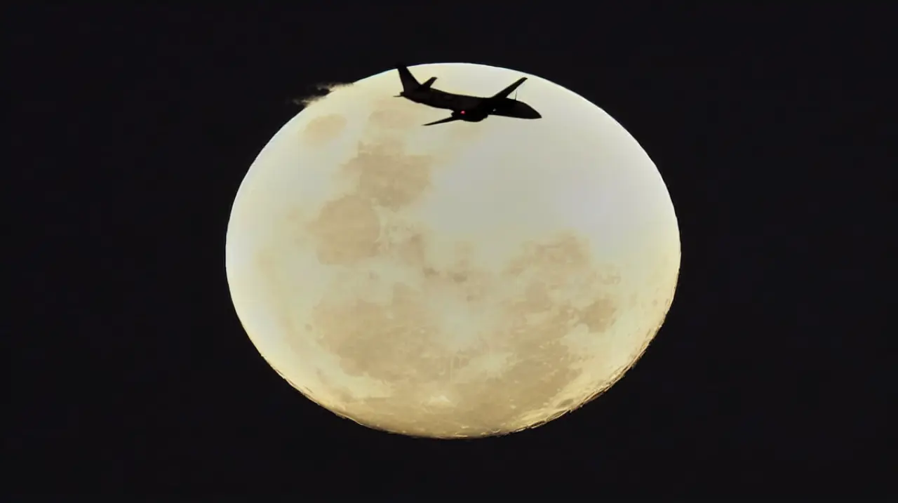 Un avión y la luna llena, en una toma casi perfecta